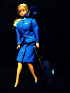 a doll in a blue uniform