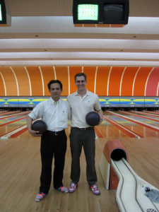 men standing in front of bowling alley