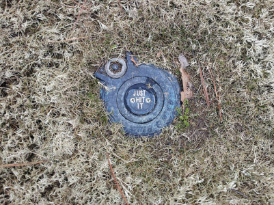 a metal object in the grass