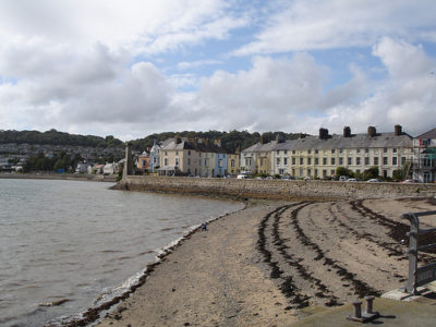 a beach with buildings and water