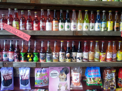 a shelf with bottles and candy