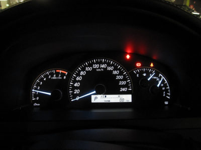 a car dashboard with a speedometer and indicator