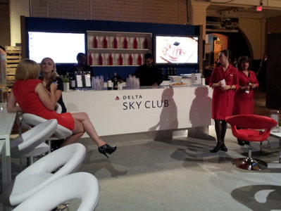 a group of women in red dresses at a bar