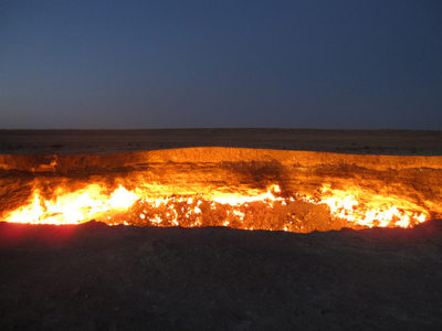 a large hole in the ground with a fire coming out of it