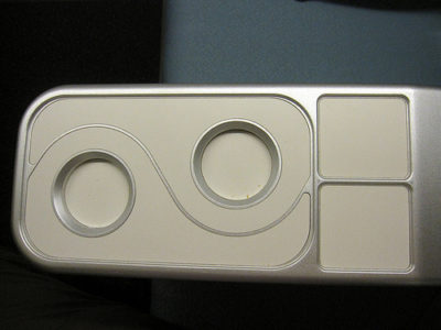 a white rectangular object with circles and a few square buttons