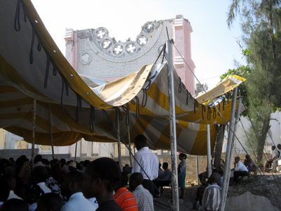 a group of people sitting under a tent