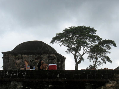 a group of people sitting on a wall