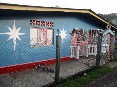 a blue house with white stars on the wall