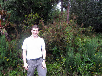 a man standing in front of a tree