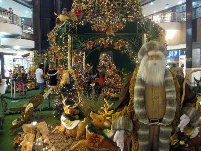 a large green structure with a large santa claus and reindeer