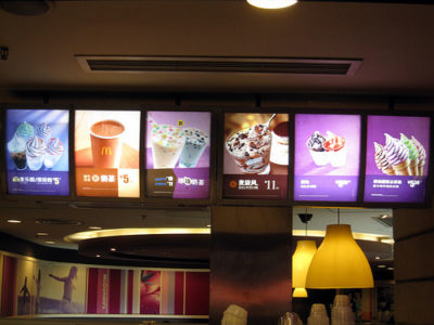 a menu board with pictures of fast food
