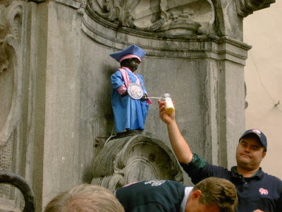 a man pouring milk into a statue