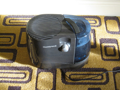 a black and grey machine on a yellow and black rug