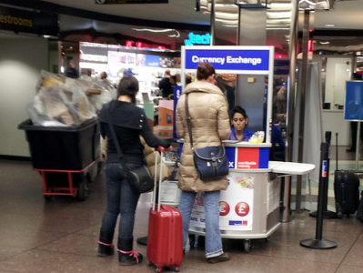 a woman standing next to a woman with a luggage