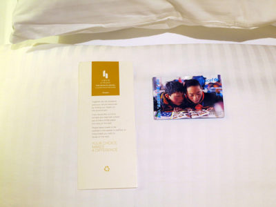 a book and a card on a bed