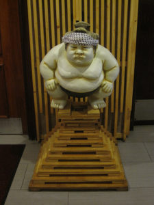 a statue of a sumo wrestler
