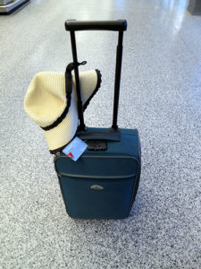 a hat and luggage on the floor