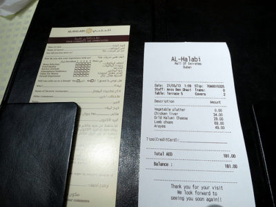 a receipt and a wallet on a table