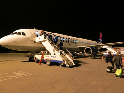 a plane with people boarding