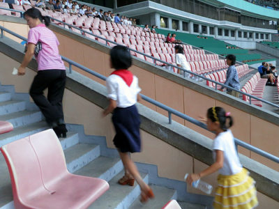 people walking up stairs in a stadium