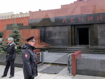 two men in uniform standing outside a building