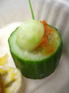 a cucumber with a small round object on top