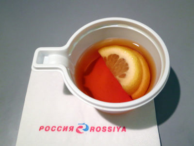 a cup of tea with lemon slices in it