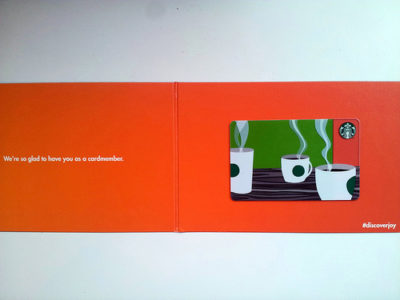 an orange rectangular gift card with a picture of coffee cups