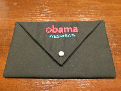 a black envelope with a button on it