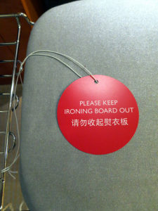 a red sign with white text on a gray surface