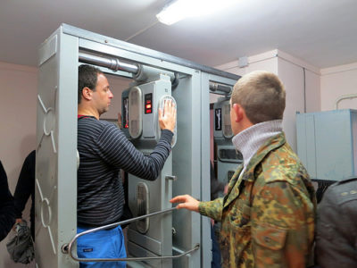 a man in a military jacket standing in a machine