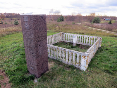 a stone pillar in a grassy field