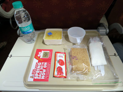 a tray with food and a bottle of water on it
