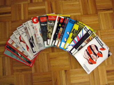a group of magazines on a wood floor