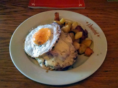 a plate of food with a fried egg and potatoes
