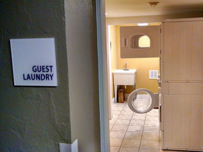 a room with a laundry machine and a washer and dryer