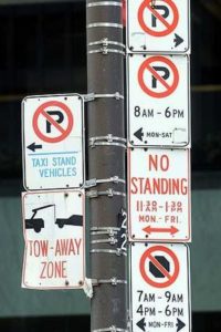 a close-up of a pole with signs
