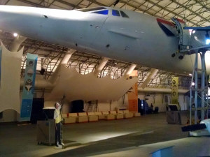 a man standing in a hangar with a plane