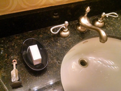 a sink with a soap dish and a lock