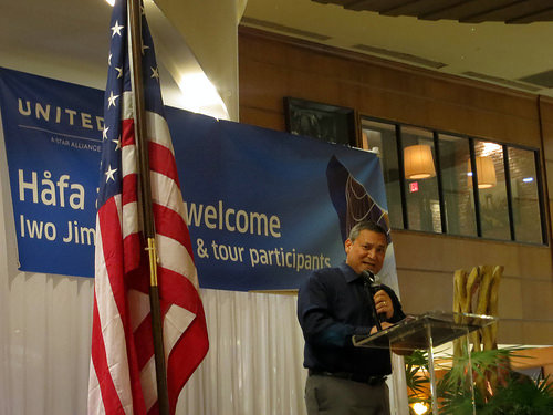 a man standing at a podium with a microphone