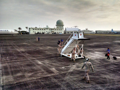 a group of people walking on a tarmac