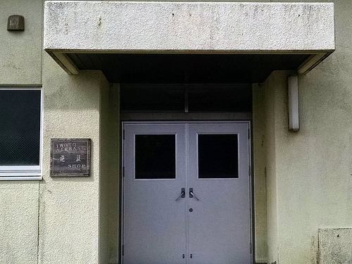 a white double doors with a sign on the wall