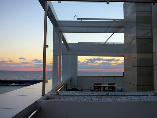 a glass wall with a view of the ocean