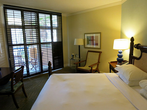 a hotel room with a bed and chairs