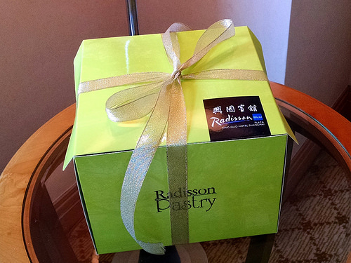 a green box with a gold ribbon