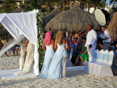 a group of people at a beach wedding