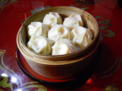 a bowl of dumplings on a red surface