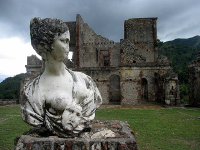 a statue of a woman in front of an old building