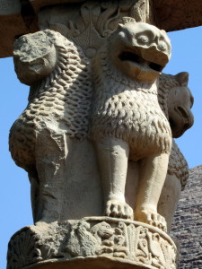 a stone statue of a lion and a lion