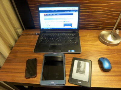 a laptop and cell phones on a desk